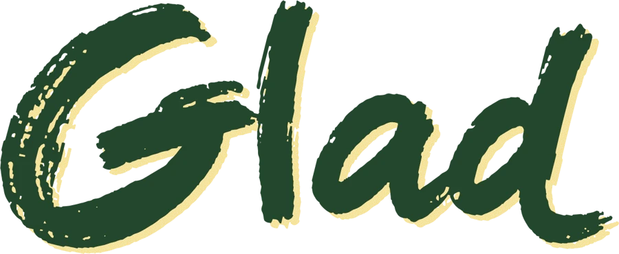 The word Glad from the logo, printed in green with the butter plate set slightly down and to the right