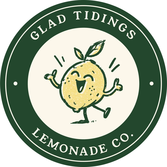 Round Glad Tidings seal with a leaf-green ring and Sunny in the center